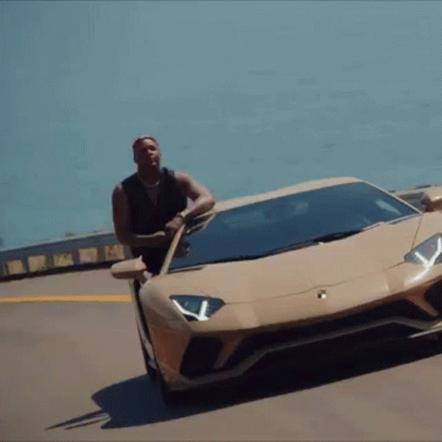 Man Leaning on Lamborghini Aventador