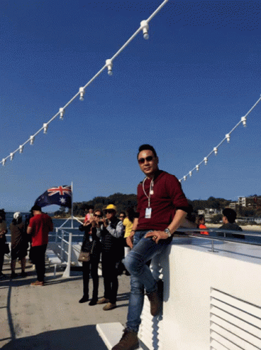 Man Leaning on Railing with Australian Flag