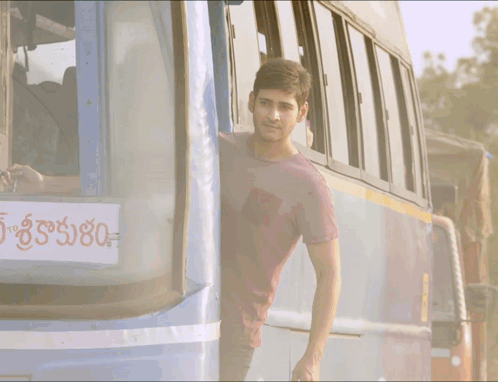 Man Leaning Out of Blue Bus Saying 80