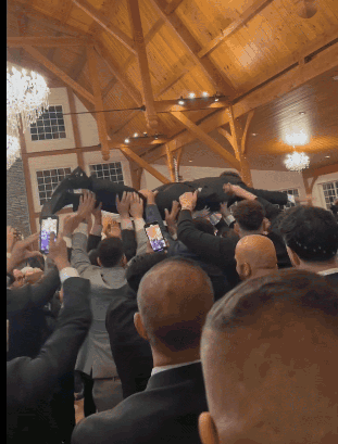 Man Lifted in Air by Group of People