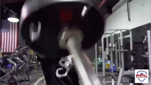 Man Lifting Barbell in Gym With PFL Logo