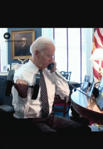 Man Lifting Dumbbell Talking on Phone