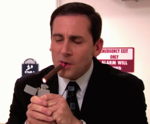 Man Lighting Cigar Near Emergency Exit