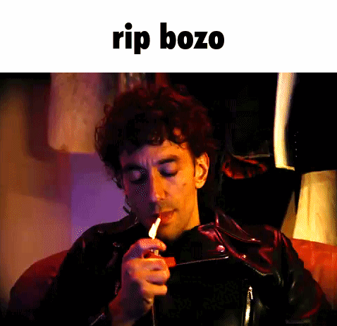 Man Lighting Cigarette With Rip Bozo GIF