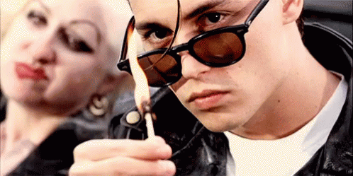 Man Lighting Lighter Next To Woman GIF