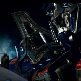 Man Looking at Blue Robot With Helmet
