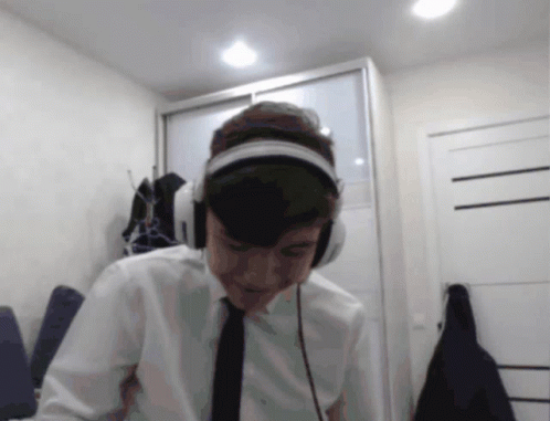 Man Looking at Camera With Headphones and Tie