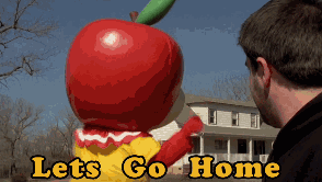 Man Looking at Giant Apple Mascot Saying Lets Go Home