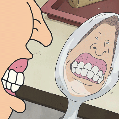 Man Looking at His Mouth in a Mirror