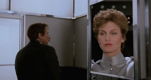 Man Looking at Woman's Reflection