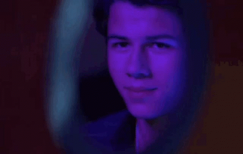 Man Looking In Mirror With Purple Light GIF