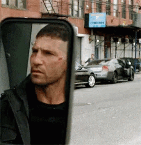 Man Looking in Rear View Mirror