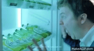 Man Looking into Refrigerator with Sprite