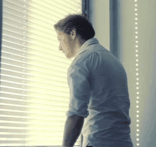 Man Looking Out Window With Blinds GIF