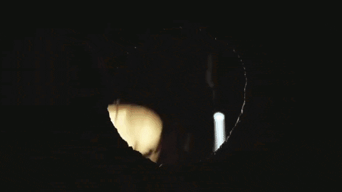Man Looking Through Hole