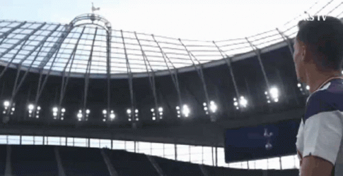 Man Looking Up at Soccer Stadium Roof