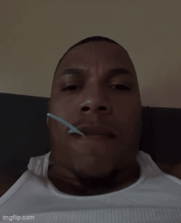 Man Lying Down With Spoon In Mouth GIF
