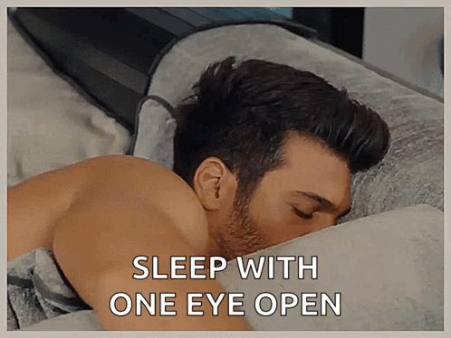 Man Lying in Bed Sleep With One Eye Open