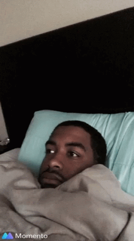 Man Lying in Bed with Blue Pillow