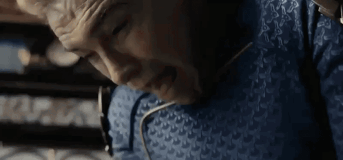 Man Lying in Blue Chair with Eyes Closed