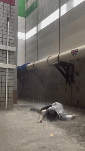 Man Lying in Flood, Danger Do Not Enter