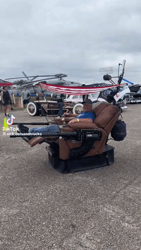 Man Lying in Recliner Parking Lot