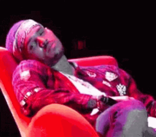 Man Lying in Red Chair