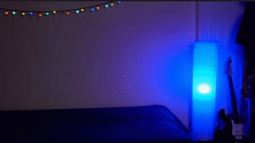 Man Lying on Another's Back in Dark Room With Blue Lamp