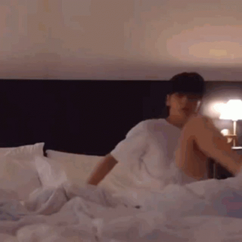 Man Lying on Bed With Legs Crossed