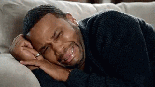 Man Lying on Couch Crying