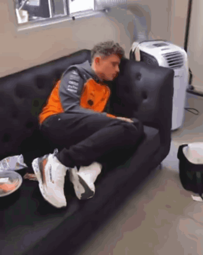 Man Lying On Couch Next To Air Conditioner GIF