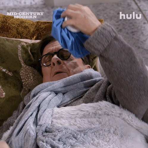 Man Lying on Couch with Ice Pack