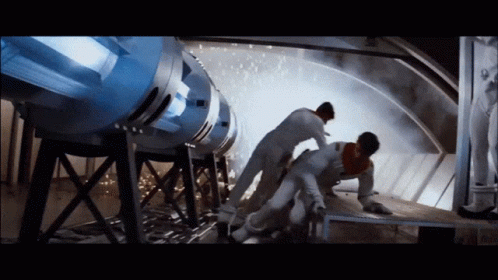 Man Lying on Ground by Large Machine