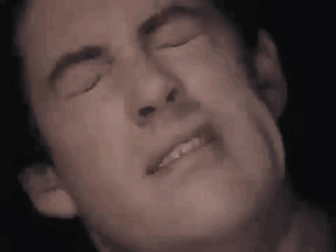 Man Making Face With Eyes Closed