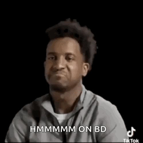 Man Making Funny Face And Pointing At Camera In Grey Shirt GIF