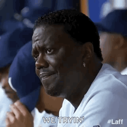 Man Making Funny Face in Dugout with Team