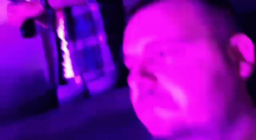 Man Making Funny Face In Front Of Purple Light GIF