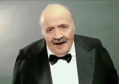 Man Making Funny Face In Suit Bow Tie GIF