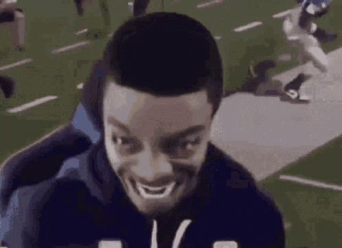 Man Making Funny Face on Chair in Football Field