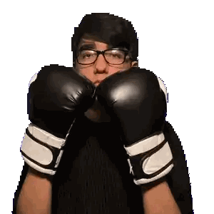 Man Making Funny Face with Boxing Gloves and Glasses