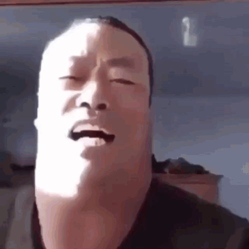 Man Making Funny Face With Eyes Closed in Sun