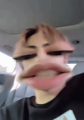 Man Making Funny Face with Mouth Open in Car