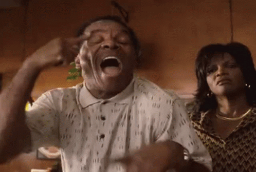Man Making Funny Face With Woman Behind Him GIF