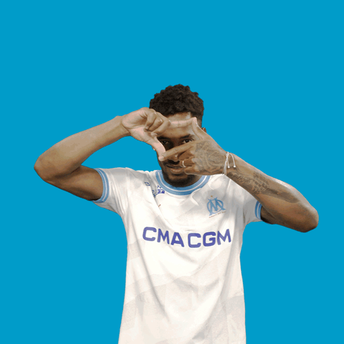 Man Making Heart Shape Wearing Macm Shirt