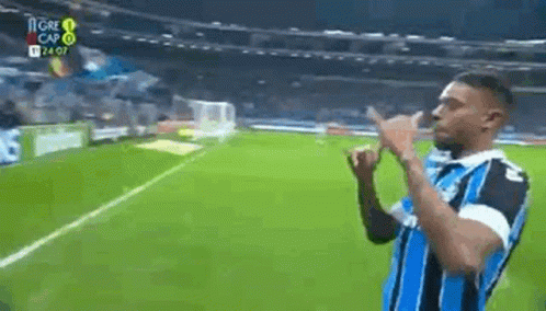 Man Making Peace Sign on Soccer Field
