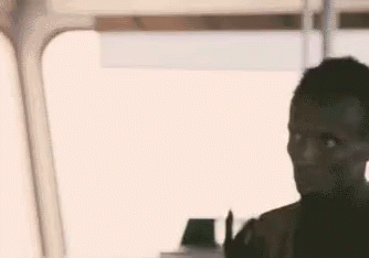 Man Making Peace Sign Sitting On Train GIF