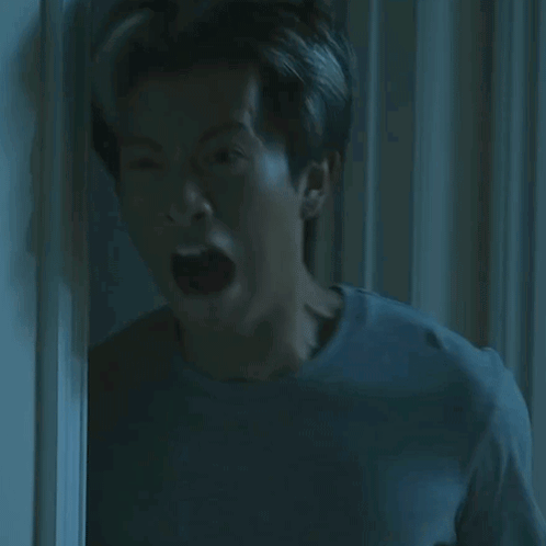 Man Mouth Open In Dark Room GIF