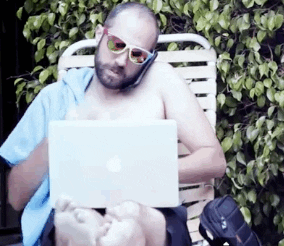 Man Multitasking While Relaxing GIF