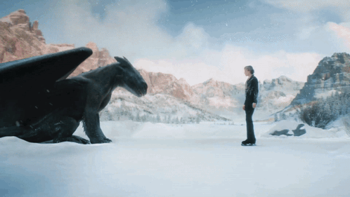 Man Next to Black Dragon in Snow