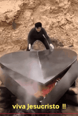 Man Next to Large Metal Heart Viva Jesucristo